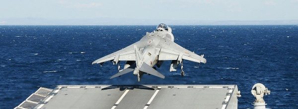 How do planes take off and land on aircraft carriers?